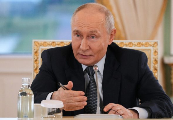 Russian President Vladimir Putin meets with representatives of international news agencies on the sidelines of the St. Petersburg International Economic Forum